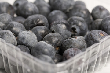 Large blueberries in a decorative container. International day without diets. Close-up.