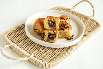 pisang bolen is made from bananas covered in rolled sheet of pasrty dough. various topping such as cheese and chocolate. selective focus