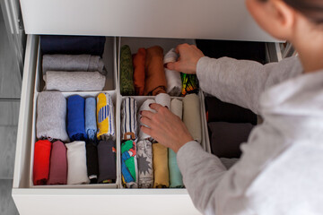 Vertical storage of clothing. Clothing folded for vertical storage in the linen drawer. Nursery. Room interior. 