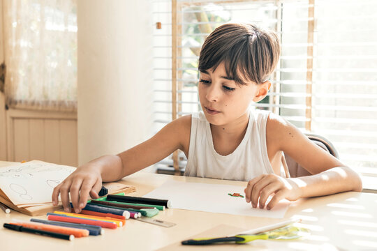 Child drawing in a bright environment.