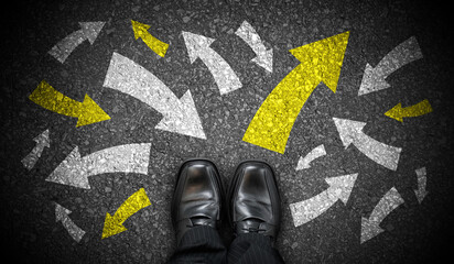 Black business shoes and many chalky arrows in various directions - chaos concept