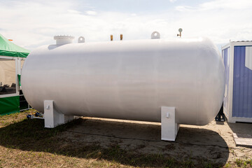 large white liquid storage tank outside. barrel for fuel or water
