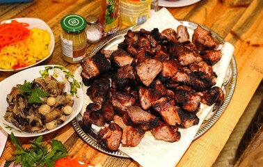Toasty pork skewers on a plate. Grilled at home.