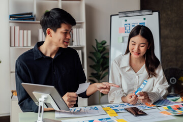 young husband and wife  working at office by new project and happy