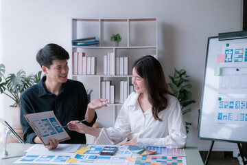 Happy young Asian couple enjoying in working time, watching on line chart. Smiling woman Happy.