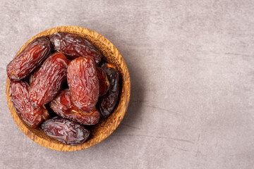 dates in a wooden bowl, high angle view