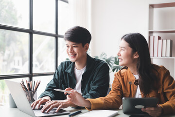 young husband and wife working at office by new project and happy.
