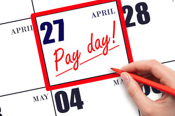 Hand writing text PAY DATE on calendar date April 27 and underline it. Payment due date