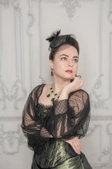 Portrait of Beautiful young woman wearing green medieval vintage Victorian Style dress