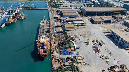 Oil tanker ship at dry dock concept maintenance service. working at dry dock. Insurance and Maintenance Crude tanker Ship concept. Freight Forwarding Service maintenance Insurance