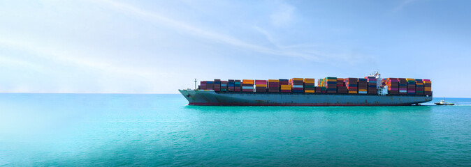 Side Ship view of Cargo Container Ship with Tug boat carrying container and running very fast for export cargo from container yard port to custom ,Contrail line in the ocean - obrazy, fototapety, plakaty