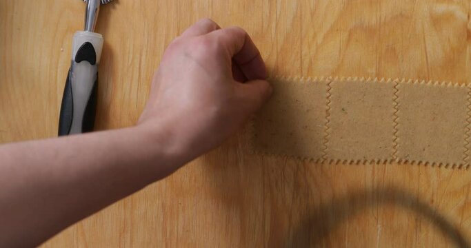Pastry Perfection: Craftsmanship with a Pastry Cutter for Chebakia. Each Cut Shapes the Dough with Culinary Expertise