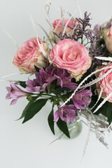 Beautiful rose flowers bouquet on white background. Flat lay, top view floral composition