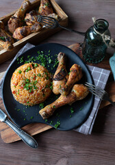 Djuvec rice with baked chicken drumsticks on a plate
