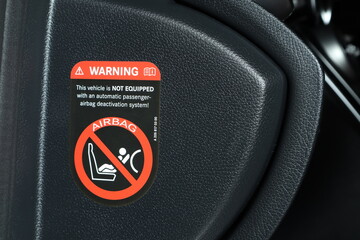 airbag warning sticker on the interior car console about no equipped automatic passenger airbag...