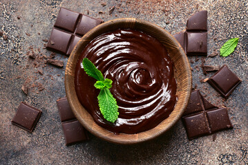 Homemade mint chocolate ganache in a wooden bowl. Top view with copy space.
