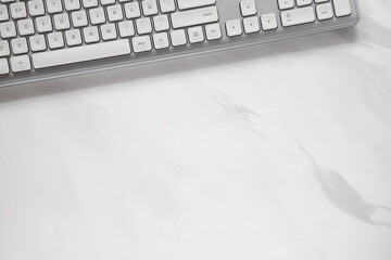 White computer keyboard, office background