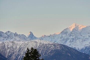 Landscape view of the snow-covered Swiss mountains in the morning glow