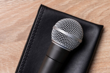 black dynamic microphone on black leather case 