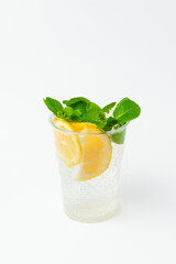 Vertical shot of a fresh lemonade in a to go plastic glass with mint leaves.