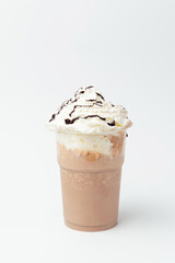Vertical shot of a chocolate milkshake with a lot of whipped cream on top.