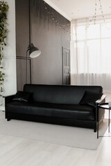 Black leather sofa in the interior