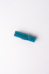 blue wooden clothespin on white background