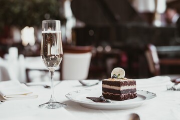 Chocolate cake with a glass of wine on Christmas table