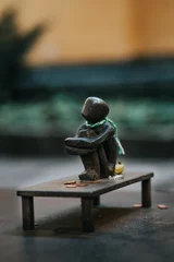 Foto op Plexiglas Historisch gebouw Vertical shot of the smallest sitting iron boy statue in Stockholm, Sweden