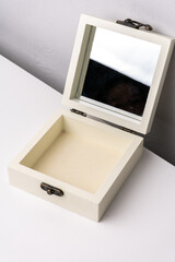 Open jewelry box with mirror on white background