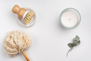 sustainable lifestyle concept flat lay with bamboo brush, dusting brush and candle on white background