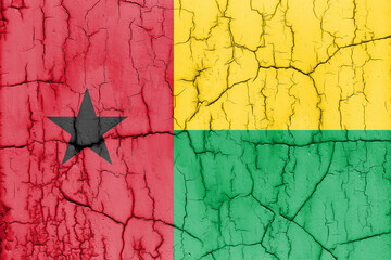 Flag of Guinea-Bissau on cracked wall, textured background.