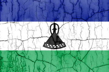 Flag of Lesotho on cracked wall, textured background.