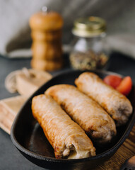 Grilled sausage on pan close up