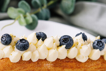 Tasty French eclairs with cream and fresh berries