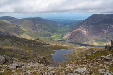 Fototapeta na wymiar Aerial view of the Ogwen Valley in between a mountain range, in Snowdon in Wales, on a cloudy day