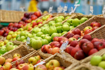 Shelf with fruits on a farm market. Green and red apples, selective focus