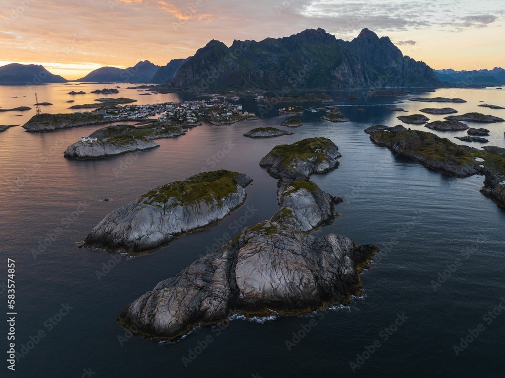 Poster Aerial view of the sea with small rocky islands at a beautiful pink sunset