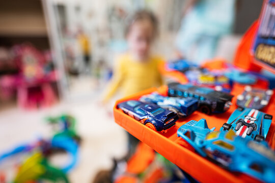 Kyiv, Ukraine - March, 2023: Kids play with collection of colorful toy cars. Hot Wheels Ultimate garage.
