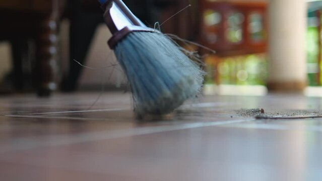 A broom sweeping a dusty balcony.