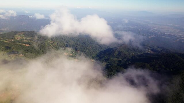 Aerial view of mountain landscape surrounded by dense trees during sunset