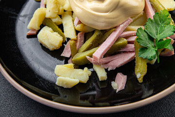 salad gherkin, potato, sausage, mayonnaise ready to eat meal food snack on the table copy space food background rustic top view