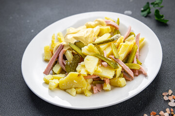 salad gherkin, potato, sausage, mayonnaise ready to eat meal food snack on the table copy space food background rustic top view