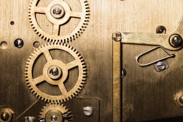 Vintage clock mechanism, close up photo of brass gears