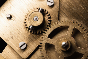 Fototapeta na wymiar Gear made of brass, vintage clock mechanism close up photo