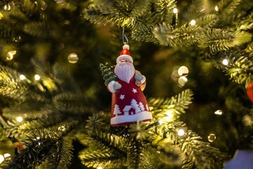 Santa Claus toy hanging on Christmas tree