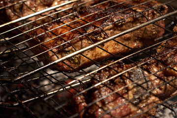 Large chunks of juicy meat are fried in a grid