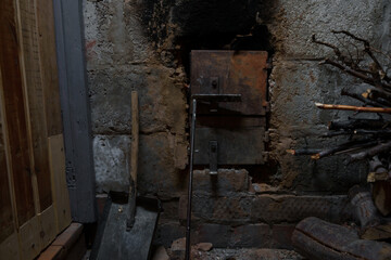 Fototapeta na wymiar wood burning stove and brick wall fired