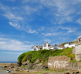 Buildings on the cliff above the beach in the traditional fishing village of Port Isaac, Cornwall