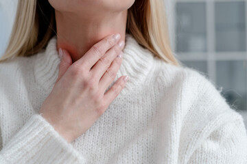 closeup of young woman with sore throat, health care concept